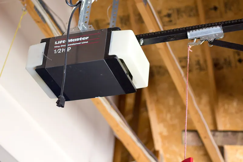 Chain-drive garage door opener motor mounted to the ceiling
