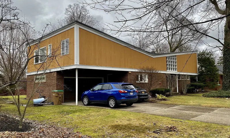 House with an attached garage and car parked in the driveway
