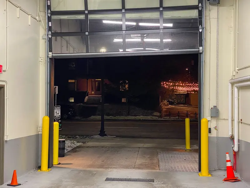 Commercial loading dock with an overhead door and safety bollards