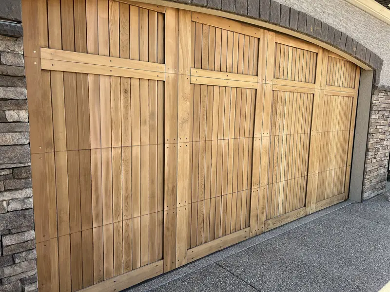 Cedar carriage-style garage door after sanding, before refinishing